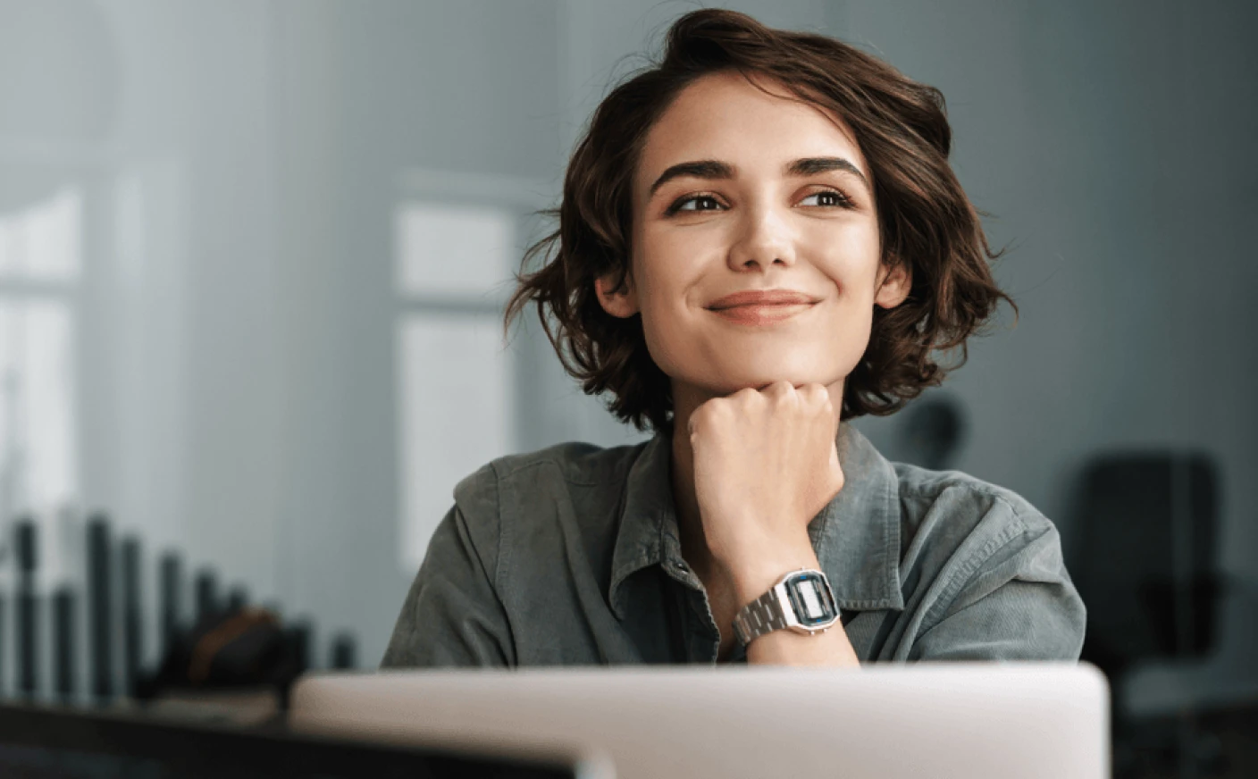 Counsellor smiling while working on a laptop